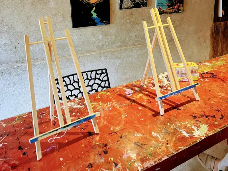 Small easels on a paint-splattered studio table