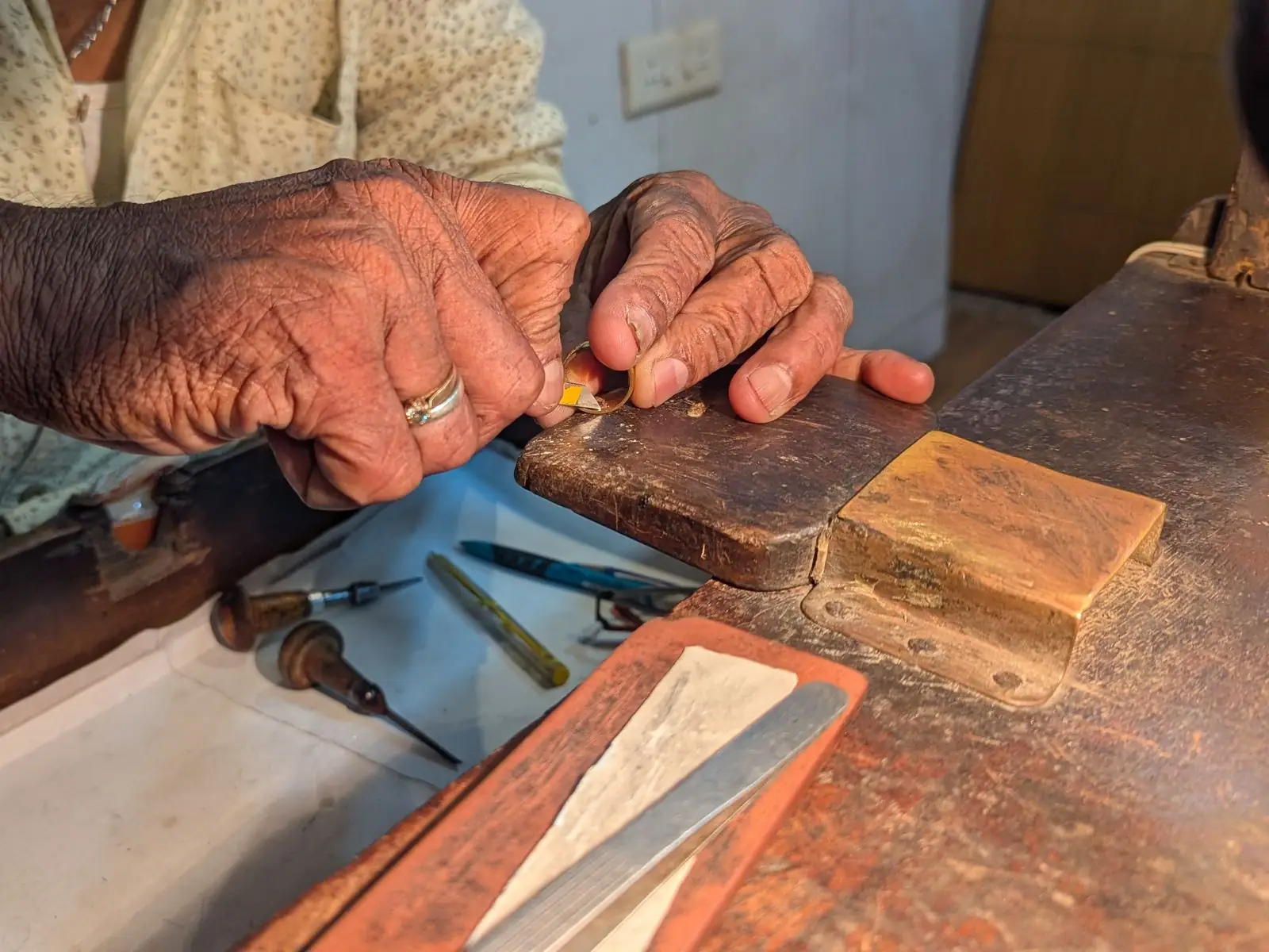 A jeweller's hands at work at the bench